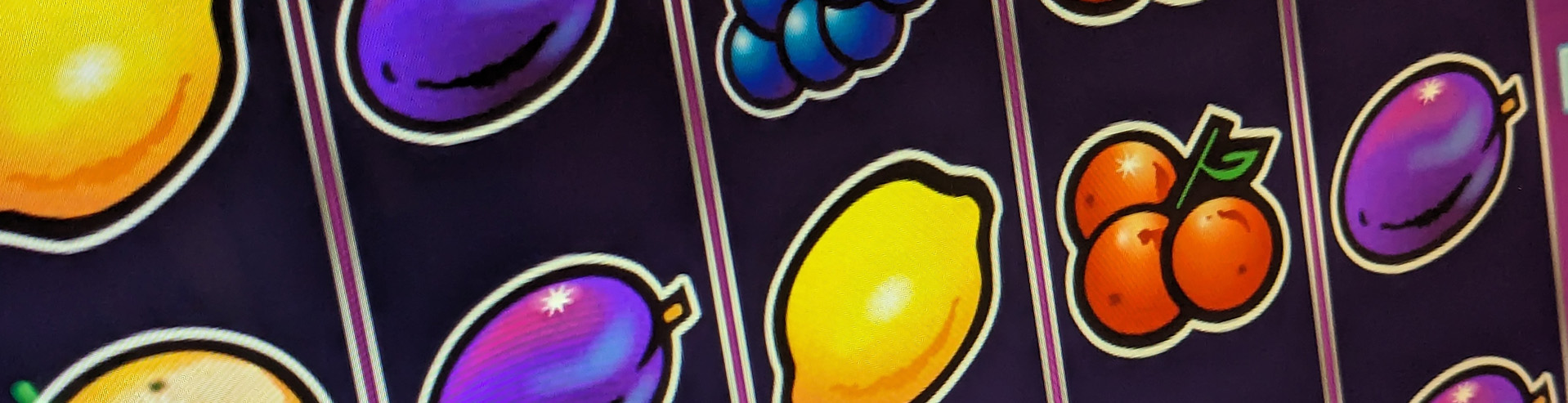 A slot machine screen displaying fruit symbols